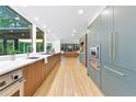 A chef's kitchen featuring stainless appliances, custom cabinets and countertops, hardwood floors and an open concept at 4601 Tall Pines Nw Dr, Atlanta, GA 30327