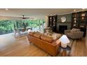 An expansive living room boasts a fireplace, hardwood floors, and views of the lush outdoor landscape at 4601 Tall Pines Nw Dr, Atlanta, GA 30327