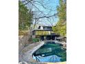 A luxurious pool is nestled among trees in the backyard of this stunning home at 4601 Tall Pines Nw Dr, Atlanta, GA 30327