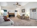 A bright living room features a ceiling fan and a stone fireplace, creating a cozy ambiance at 7847 Dogwood Way, Douglasville, GA 30134