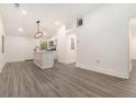 Open-concept living area with a kitchen island, modern lighting, and sleek flooring, perfect for entertaining at 2174 Rexford Dr, Decatur, GA 30034