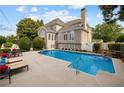 Gorgeous pool with a waterfall feature, lounge chairs, and beautifully landscaped backyard at 3495 Mill Bridge Dr, Marietta, GA 30062