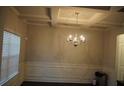 Elegant dining room featuring a coffered ceiling and a stylish chandelier at 1504 Gallup Dr, Stockbridge, GA 30281