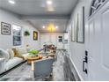 Open concept living and dining area featuring a neutral palette, modern lighting, and new gray vinyl floors at 2162 Westover Dr, Atlanta, GA 30344