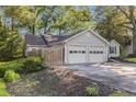 Home with an attached two-car garage, and driveway, surrounded by mature trees and landscaping at 2701 Log Cabin Se Dr, Atlanta, GA 30339