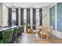 Bright dining area featuring modern light fixtures and an accent wall with elegant artistic design at 126 Chestnut Cir, Atlanta, GA 30342