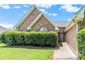 Brick home with lush hedge, manicured lawn, and charming curb appeal in a serene setting at 1478 Elena Dr, Mcdonough, GA 30253