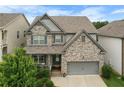 Charming two-story home with a well-manicured lawn and a two-car garage at 216 Orchard Trl, Canton, GA 30115