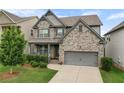 Charming two-story home with a well-manicured lawn and a two-car garage at 216 Orchard Trl, Canton, GA 30115