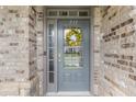 Close-up of a charming front door with a decorative wreath and sidelight window at 216 Orchard Trl, Canton, GA 30115