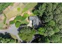 Expansive aerial view of home nestled among mature trees in established neighborhood on a large manicured lot at 3600 Goldenrod Dr, Alpharetta, GA 30005