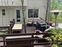 Spacious outdoor deck with comfortable seating and a grill, ideal for entertaining and enjoying nature at 507 Spring Creek Ne Way, Marietta, GA 30068