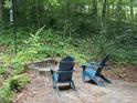 Relax outdoors on the patio with Adirondack chairs and a fire pit at 507 Spring Creek Ne Way, Marietta, GA 30068