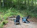 Inviting backyard firepit area with comfortable Adirondack chairs, perfect for relaxing evenings outdoors at 507 Spring Creek Ne Way, Marietta, GA 30068