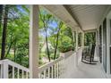Relaxing covered porch with rocking chairs and views of a lush, green neighborhood at 507 Spring Creek Ne Way, Marietta, GA 30068