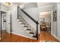 Inviting entryway with hardwood floors and a staircase with a black railing and gray carpet at 507 Spring Creek Ne Way, Marietta, GA 30068