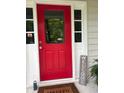 Charming red front door with glass panel and decorative welcome sign, inviting guests into a warm and welcoming home at 507 Spring Creek Ne Way, Marietta, GA 30068