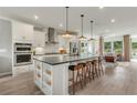 Spacious kitchen features a large island, stainless appliances, and modern lighting at 1088 Battery Park Rd, Decatur, GA 30033