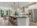 Bright and airy kitchen with oversized island, stainless fridge, and pendant lighting at 1088 Battery Park Rd, Decatur, GA 30033