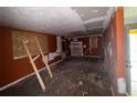 Spacious living room awaiting renovation, featuring boarded windows and original architectural details at 1101 Isa Se Dr, Atlanta, GA 30315