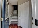 View through the front door to an entryway featuring wood floors and staircase at 3187 Mill Springs Cir, Buford, GA 30519
