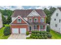 Beautiful two-story brick home featuring well-maintained landscaping and a welcoming covered front porch at 5280 Lakerock Way, South Fulton, GA 30331