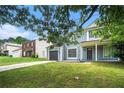Charming two-story home featuring a well-maintained lawn, attached garage, and inviting front porch at 6279 Marbut Farms Rd, Lithonia, GA 30058