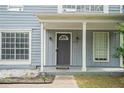 Inviting front entry with a classic door, decorative columns, and well-manicured landscaping at 6279 Marbut Farms Rd, Lithonia, GA 30058