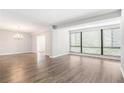 Large living room with wood-look floors, large windows, and chandelier lighting fixture at 1800 Clairmont Lk # 412, Decatur, GA 30033