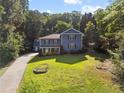 Attractive home with a well-manicured lawn, lush landscaping and a long driveway at 2067 Kinridge Ct, Marietta, GA 30062
