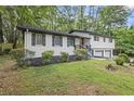 Beautiful home with a combination of white painted brick, siding, and a well-manicured lawn at 4760 Silverdale Rd, College Park, GA 30349