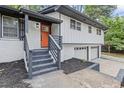 Inviting home exterior featuring freshly painted white brick and a vibrant orange front door at 4760 Silverdale Rd, College Park, GA 30349