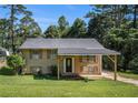Charming home with a covered carport and a well-maintained lawn at 992 Brian Ln, Forest Park, GA 30297