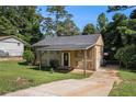 Charming home with a covered carport and a spacious concrete driveway at 992 Brian Ln, Forest Park, GA 30297