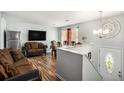 Inviting living room with wood floors, a large TV, and comfortable seating at 992 Brian Ln, Forest Park, GA 30297