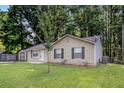 Traditional home featuring a lush green lawn, exterior shed, and side yard at 22 Cardinal Ln, Jonesboro, GA 30238