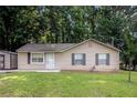 Charming single-story home features a well-maintained lawn and a convenient storage shed at 22 Cardinal Ln, Jonesboro, GA 30238