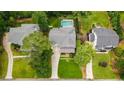 Aerial view showcases home's layout with a pool and landscaped backyard at 4048 Navajo Trl, Brookhaven, GA 30319