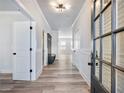 Inviting hallway with wood floors, white trim, and a view of the home's open and airy layout at 4437 Hosch Reserve Ct, Buford, GA 30519