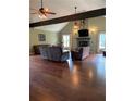 Spacious living room features a ceiling fan, hardwood floors, stone fireplace, and comfortable seating at 17 Country Walk, Cartersville, GA 30121