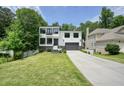 Attractive two-story home with a two-car garage, brick facade, professional landscaping, and concrete driveway at 2804 Skyland Ne Dr, Brookhaven, GA 30341