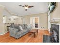 Cozy living room features a fireplace, ceiling fan, and open floor plan at 539 Mcgill Park Ne Ave, Atlanta, GA 30312