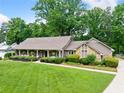 Charming single-story home with a welcoming front porch and manicured landscaping at 12162 Mountain Laurel Dr, Roswell, GA 30075