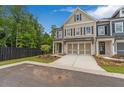 Charming two-story townhome with a neutral color palette, attached two-car garage, and well-manicured landscaping at 206 Grady Burrell Dr, Holly Springs, GA 30115