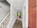 Welcoming entryway featuring hardwood floors, stairs with white railings and natural light from the adjacent living area at 3371 Spring Harbour Dr, Atlanta, GA 30340