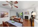 Cozy living room with hardwood floors, fireplace, and sliding glass doors leading to an outdoor space at 3371 Spring Harbour Dr, Atlanta, GA 30340