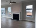 Bright living room featuring large windows, fireplace, and hardwood floors at 404 Vinca Nw Cir, Kennesaw, GA 30144