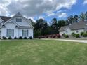Charming home with well-maintained landscaping, green grass, and vibrant azalea bushes at 605 Red Leaf Way, Canton, GA 30114