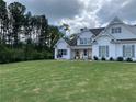 Charming two-story home with white siding, grey shutters, and a well-manicured front lawn at 605 Red Leaf Way, Canton, GA 30114