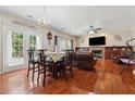 Open concept living area with hardwood floors, connecting dining and living spaces at 1093 Forest View Sw Ln, Lilburn, GA 30047